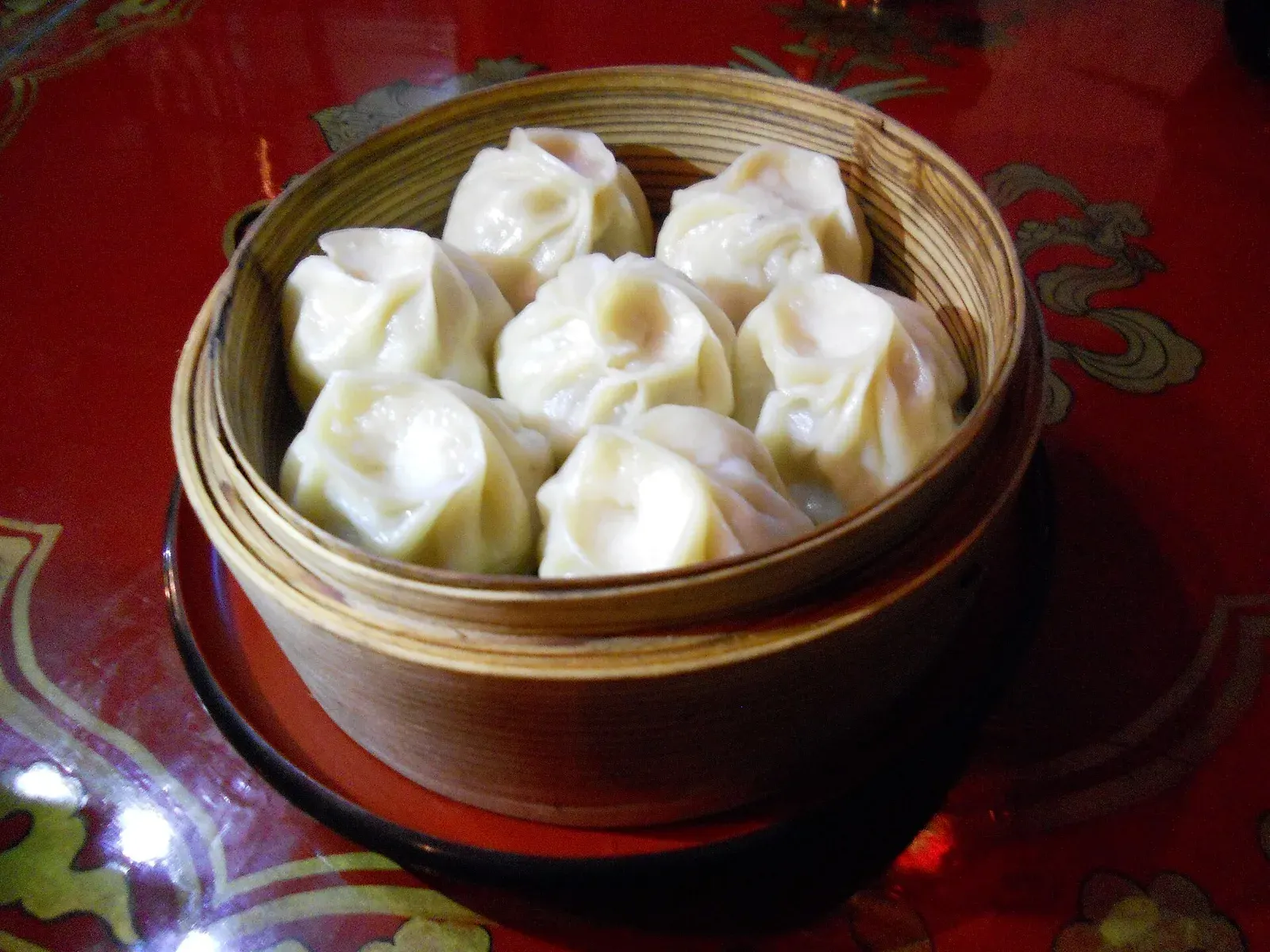 Steamed buuz, Mongolian meat dumplings, in a bamboo steamer